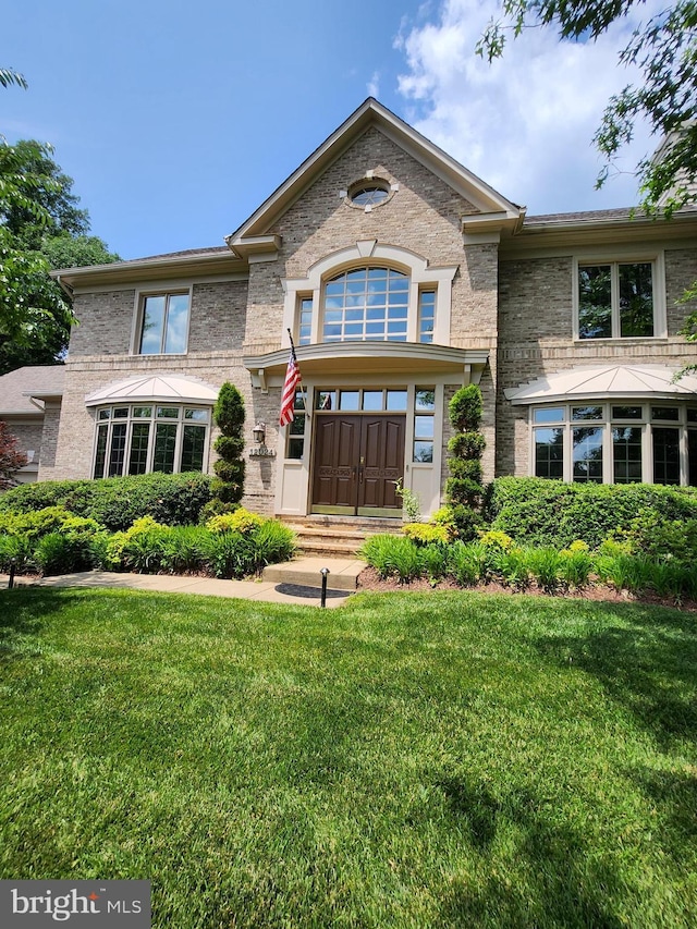12024 Walnut Branch Rd, Reston, VA 20194 - view of front of home featuring a front lawn and brick siding