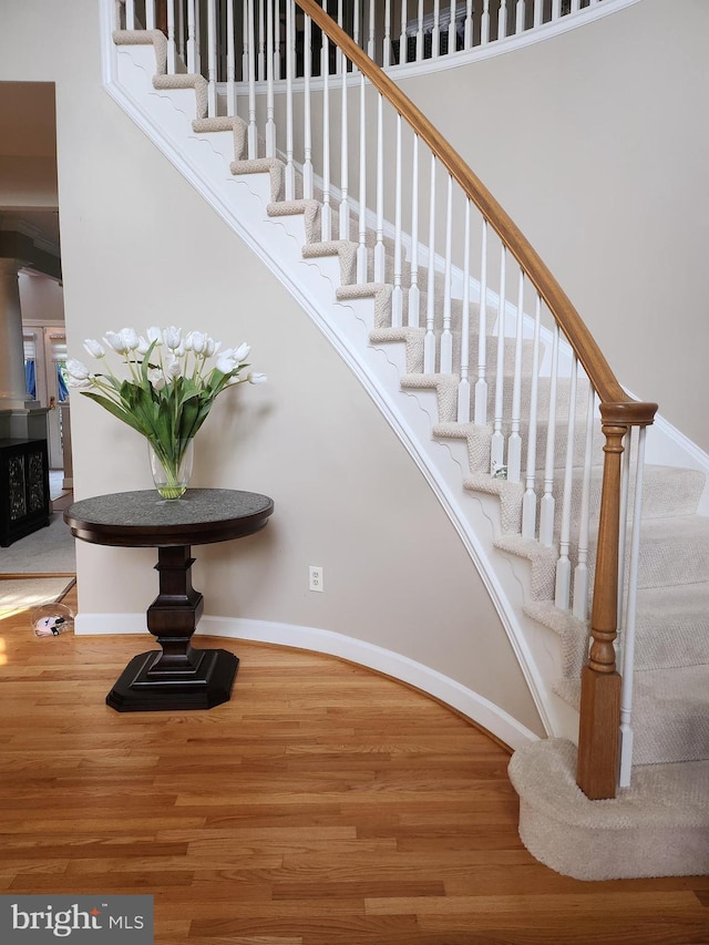 12024 Walnut Branch Rd, Reston, VA 20194 - stairway with wood finished floors, a high ceiling, and arched walkways