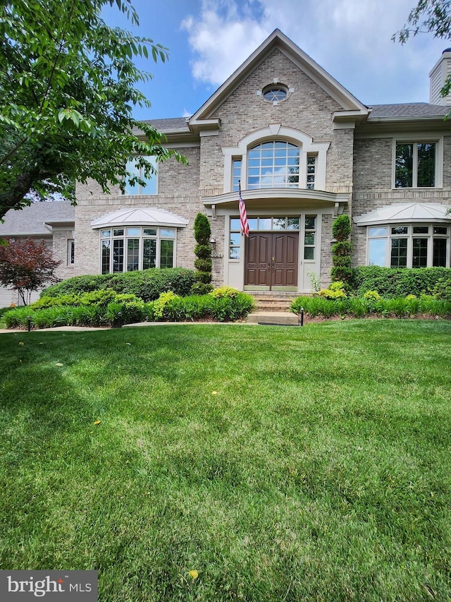 12024 Walnut Branch Rd, Reston, VA 20194 - view of front of house with a front lawn and a chimney