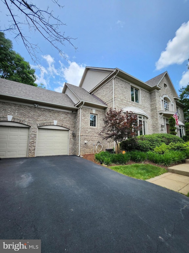 12024 Walnut Branch Rd, Reston, VA 20194 - view of side of home with driveway, a garage, and brick siding