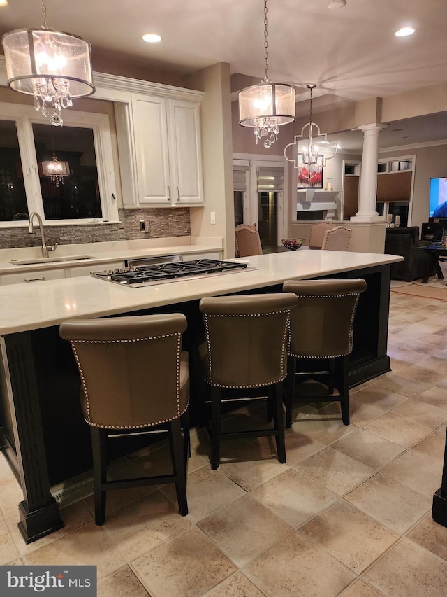 12024 Walnut Branch Rd, Reston, VA 20194 - kitchen with stainless steel gas stovetop, a chandelier, ornate columns, recessed lighting, and light countertops