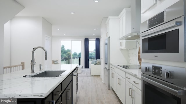 2664 River Birch Rd, Herndon, VA 20171 - kitchen with appliances with stainless steel finishes, a center island with sink, white cabinetry, recessed lighting, and light stone countertops
