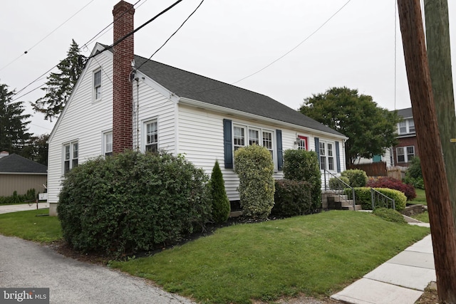 301 E Hanover St, Hanover, PA 17331 - view of side of home featuring a chimney, a yard, and roof with shingles