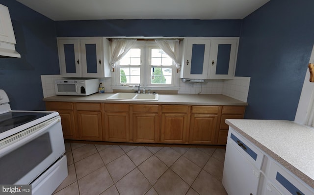 301 E Hanover St, Hanover, PA 17331 - kitchen featuring white appliances, decorative backsplash, light countertops, and under cabinet range hood