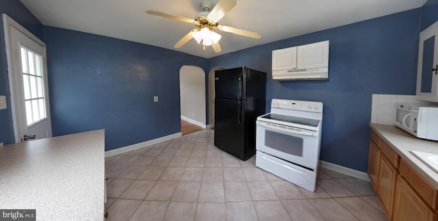 301 E Hanover St, Hanover, PA 17331 - kitchen with white appliances, under cabinet range hood, arched walkways, ceiling fan, and light tile patterned floors