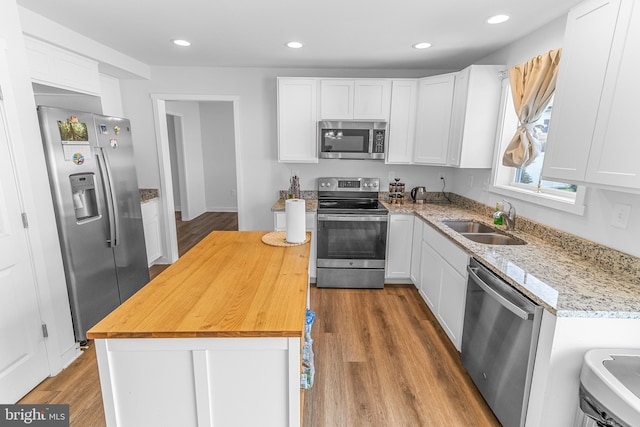 123 Hank Aaron Rd, Berkeley Springs, WV 25411 - kitchen with appliances with stainless steel finishes, wooden counters, wood finished floors, white cabinetry, and recessed lighting