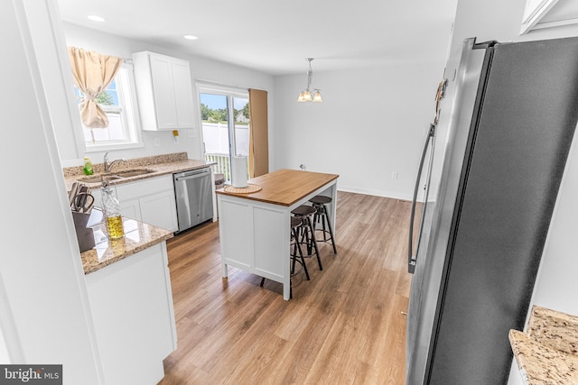 123 Hank Aaron Rd, Berkeley Springs, WV 25411 - kitchen with stainless steel appliances, white cabinetry, light wood-style floors, pendant lighting, and recessed lighting