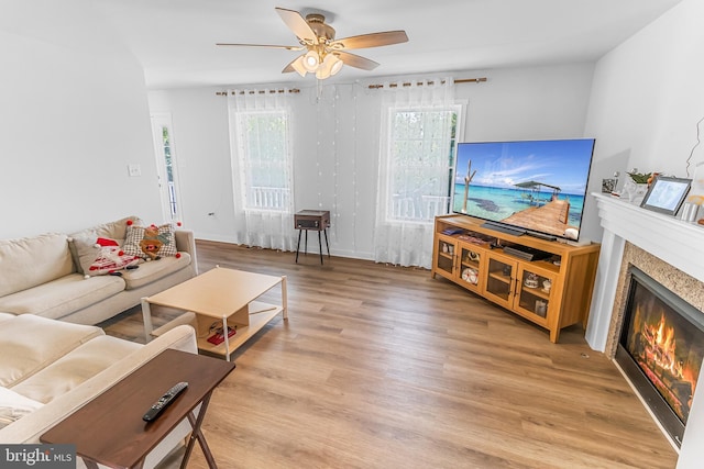123 Hank Aaron Rd, Berkeley Springs, WV 25411 - living room with ceiling fan, a glass covered fireplace, and light wood-style flooring