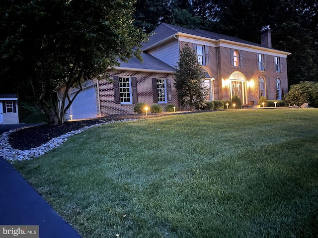 1043 Welsh Ayres Way, Downingtown, PA 19335 - view of front of home with brick siding, a chimney, a garage, and a front yard