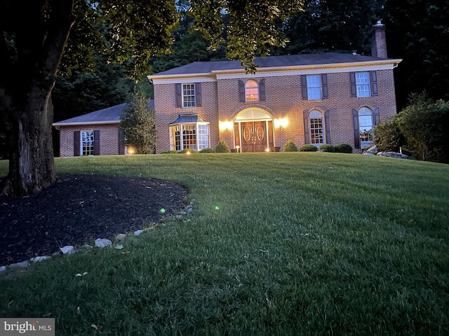 1043 Welsh Ayres Way, Downingtown, PA 19335 - georgian-style home featuring brick siding, a chimney, and a front yard