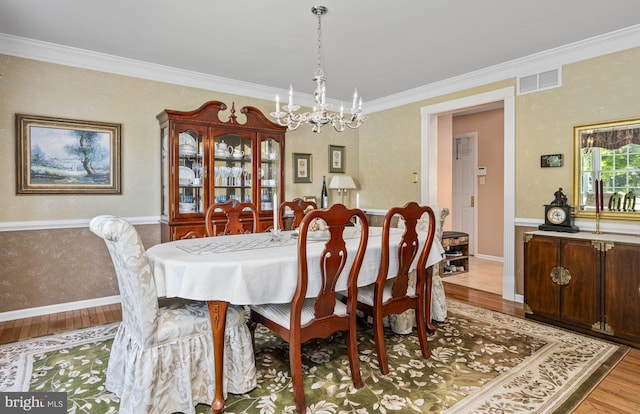 1043 Welsh Ayres Way, Downingtown, PA 19335 - dining room featuring light wood-type flooring, a chandelier, and ornamental molding