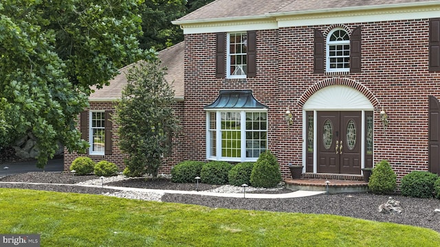1043 Welsh Ayres Way, Downingtown, PA 19335 - view of front of home featuring brick siding, roof with shingles, and a front lawn