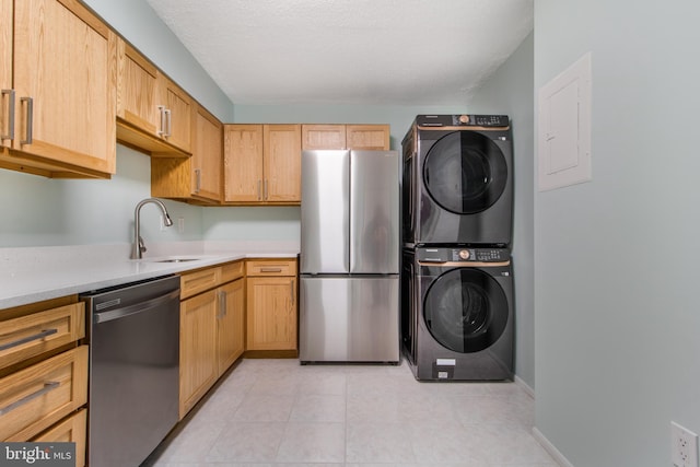 15115 Interlachen Dr Unit 3-1020, Silver Spring, MD 20906 - kitchen with stainless steel appliances, stacked washer / drying machine, light countertops, light tile patterned floors, and electric panel
