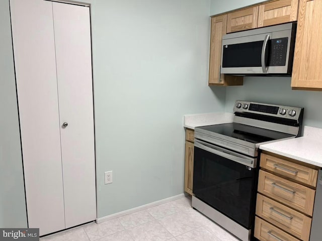 15115 Interlachen Dr Unit 3-1020, Silver Spring, MD 20906 - kitchen with appliances with stainless steel finishes, light countertops, and light tile patterned flooring