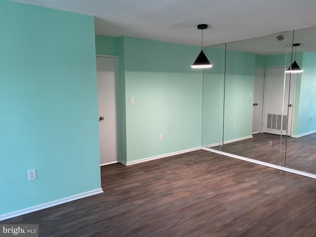 15115 Interlachen Dr Unit 3-1020, Silver Spring, MD 20906 - spare room with wood finished floors and a textured ceiling
