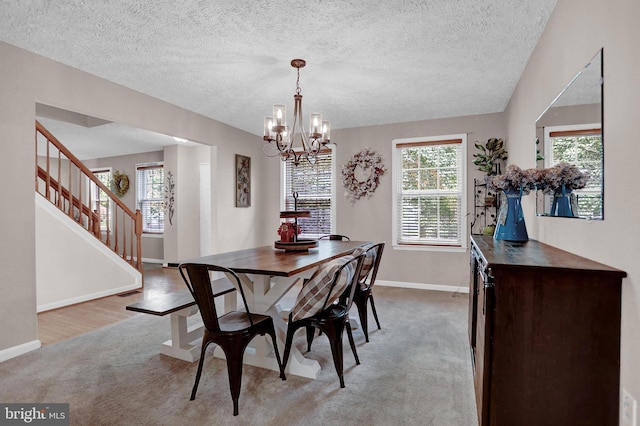 207 Weston Woods Dr, Pasadena, MD 21122 - dining room featuring light colored carpet, a chandelier, stairs, and a textured ceiling