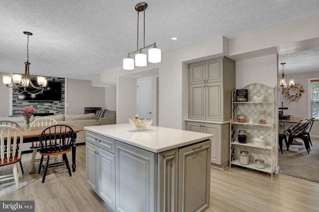 207 Weston Woods Dr, Pasadena, MD 21122 - kitchen with gray cabinets, a chandelier, a textured ceiling, and light wood finished floors