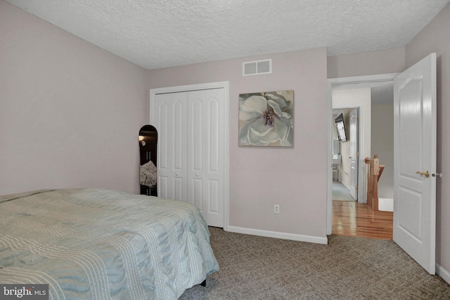 207 Weston Woods Dr, Pasadena, MD 21122 - carpeted bedroom with a closet and a textured ceiling