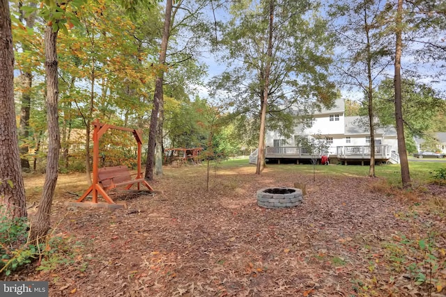 207 Weston Woods Dr, Pasadena, MD 21122 - view of yard featuring an outdoor fire pit and a wooden deck