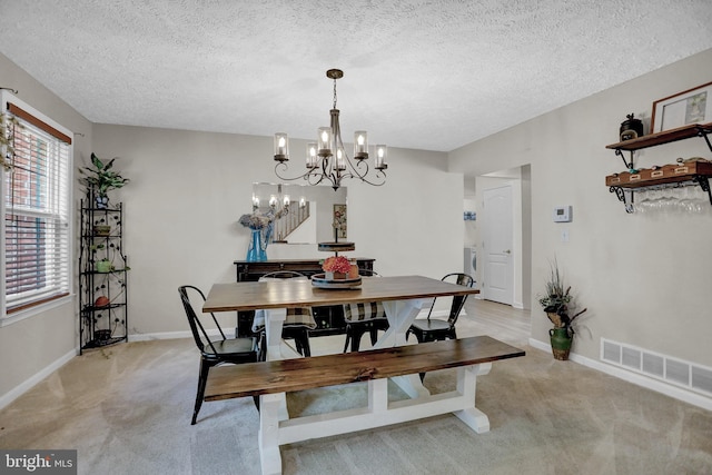 207 Weston Woods Dr, Pasadena, MD 21122 - dining room with washer / clothes dryer, light carpet, a textured ceiling, and a chandelier