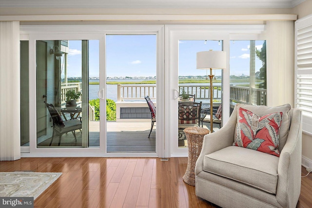222 N Heron Dr Unit 222-1, Ocean City, MD 21842 - doorway with a water view, ornamental molding, and wood finished floors