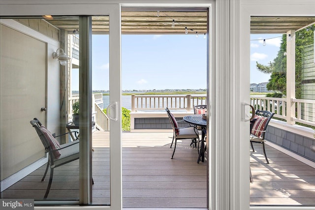 222 N Heron Dr Unit 222-1, Ocean City, MD 21842 - sunroom featuring a water view and wood finished floors