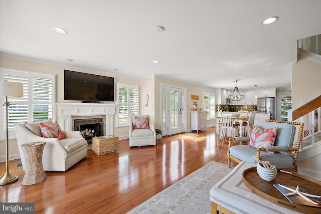 222 N Heron Dr Unit 222-1, Ocean City, MD 21842 - living room featuring light wood-style floors, a fireplace, a chandelier, recessed lighting, and ornamental molding
