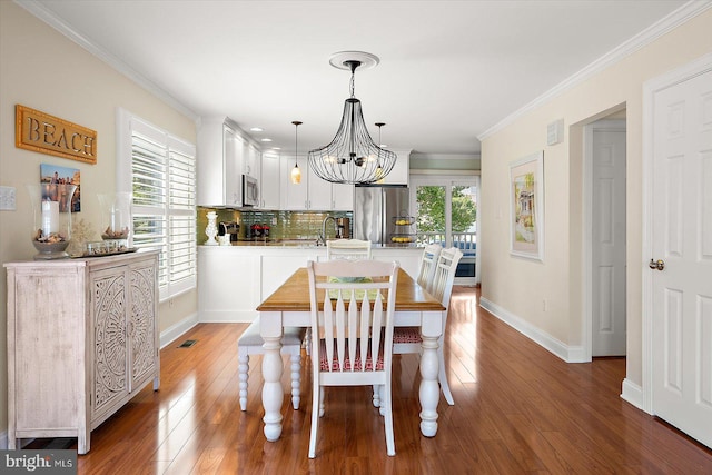 222 N Heron Dr Unit 222-1, Ocean City, MD 21842 - dining room with wood finished floors, a chandelier, and ornamental molding