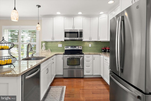 222 N Heron Dr Unit 222-1, Ocean City, MD 21842 - kitchen featuring appliances with stainless steel finishes, a peninsula, white cabinetry, decorative backsplash, and recessed lighting