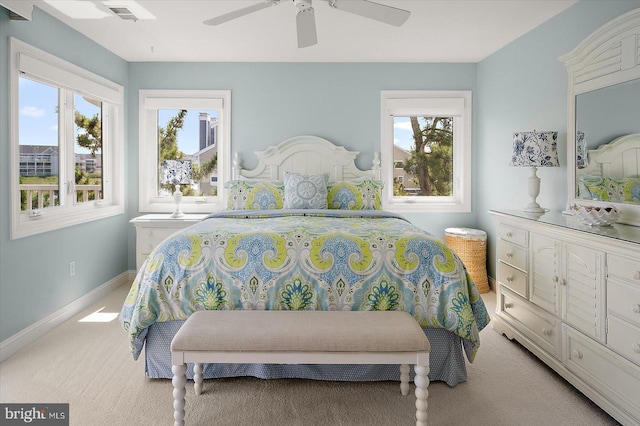 222 N Heron Dr Unit 222-1, Ocean City, MD 21842 - bedroom with light carpet, multiple windows, and a ceiling fan