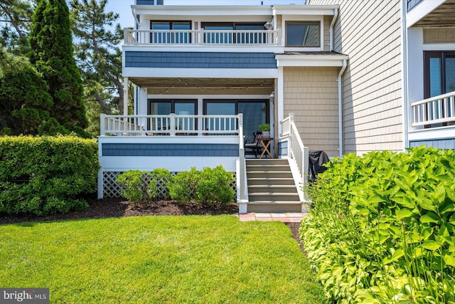 222 N Heron Dr Unit 222-1, Ocean City, MD 21842 - view of front of property featuring a balcony, a front yard, and stairway