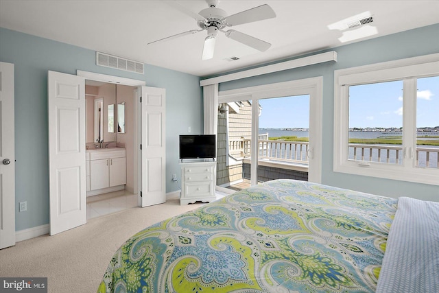 222 N Heron Dr Unit 222-1, Ocean City, MD 21842 - bedroom featuring light carpet, access to outside, ensuite bath, and a ceiling fan
