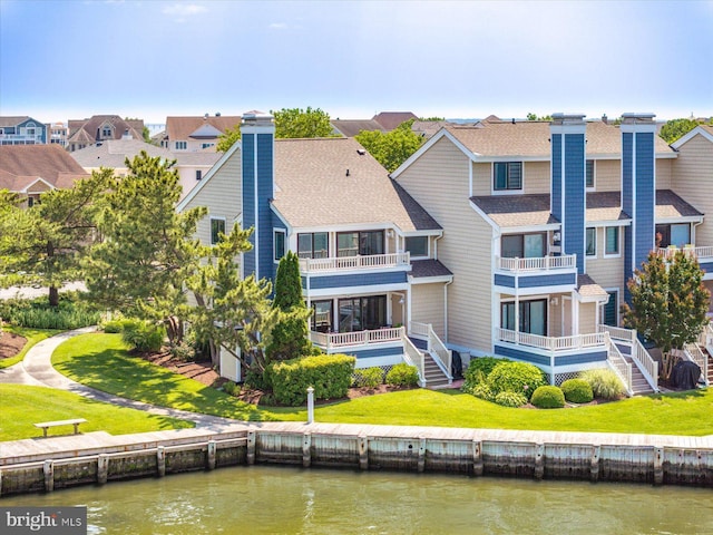222 N Heron Dr Unit 222-1, Ocean City, MD 21842 - back of house with a chimney, a balcony, a water view, a residential view, and a shingled roof