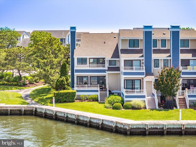 222 N Heron Dr Unit 222-1, Ocean City, MD 21842 - back of property with a water view, stairs, a shingled roof, and a chimney