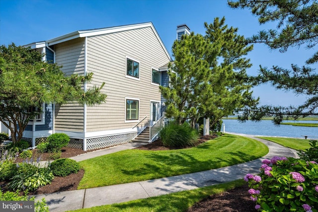 222 N Heron Dr Unit 222-1, Ocean City, MD 21842 - view of side of property featuring a water view and a lawn