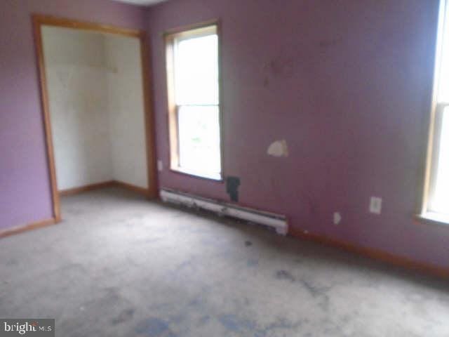 472 Lummistown Rd, Cedarville, NJ 08311 - empty room featuring a baseboard heating unit, plenty of natural light, and carpet