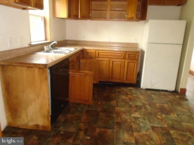472 Lummistown Rd, Cedarville, NJ 08311 - kitchen featuring black dishwasher, freestanding refrigerator, brown cabinetry, and stone finish floors
