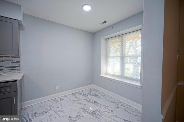 16 Franklin Dr, Voorhees, NJ 08043 - unfurnished dining area featuring light marble finish flooring and baseboards