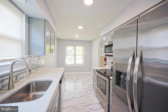 16 Franklin Dr, Voorhees, NJ 08043 - kitchen with stainless steel appliances, light marble finish flooring, recessed lighting, decorative backsplash, and light stone counters