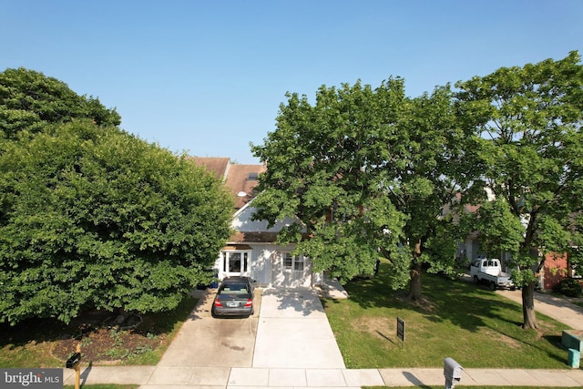 16 Franklin Dr, Voorhees, NJ 08043 - view of property hidden behind natural elements with driveway, a front lawn, and stucco siding