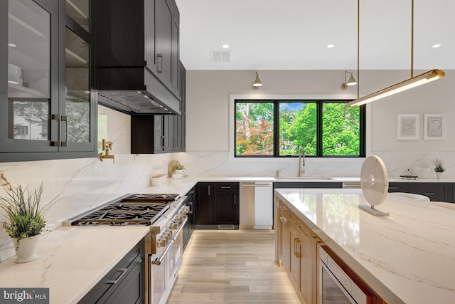 1710 Fairview Ave, Mclean, VA 22101 - kitchen featuring appliances with stainless steel finishes, light stone counters, backsplash, glass insert cabinets, and recessed lighting