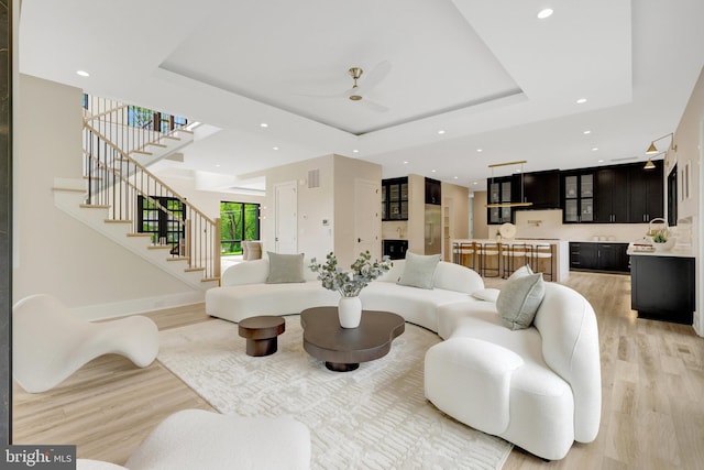 1710 Fairview Ave, Mclean, VA 22101 - living room featuring light wood finished floors, recessed lighting, stairs, a raised ceiling, and ceiling fan