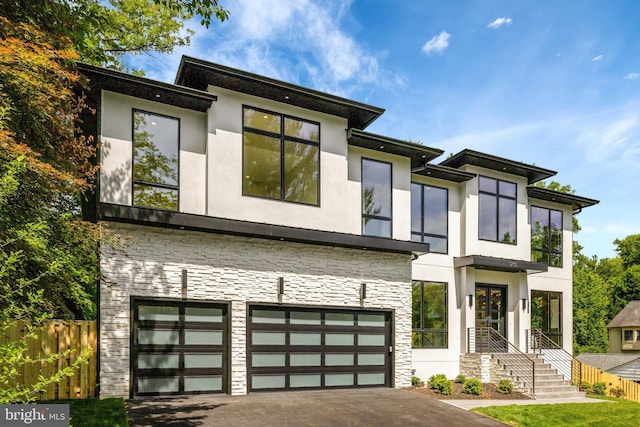 1710 Fairview Ave, Mclean, VA 22101 - contemporary home with stucco siding, stone siding, an attached garage, and asphalt driveway