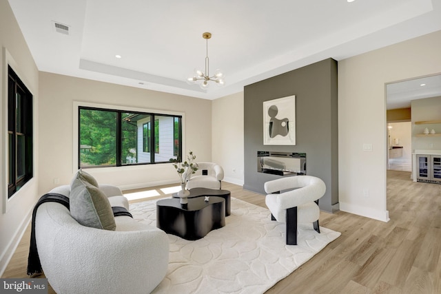 1710 Fairview Ave, Mclean, VA 22101 - living room featuring light wood-type flooring, a tray ceiling, wine cooler, recessed lighting, and a chandelier