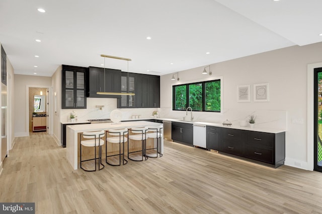 1710 Fairview Ave, Mclean, VA 22101 - kitchen with dishwasher, backsplash, light countertops, dark cabinets, and a breakfast bar area