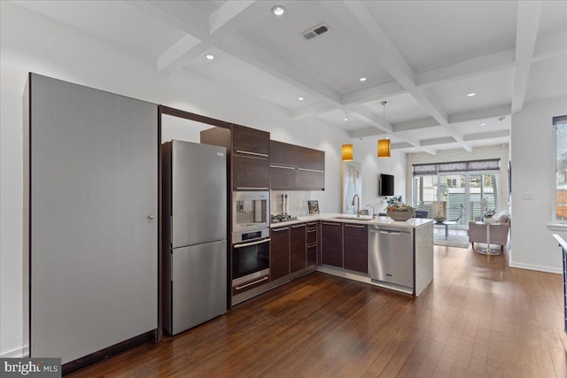 2223 1st St NW Unit 1, Washington, DC 20001 - kitchen featuring appliances with stainless steel finishes, coffered ceiling, modern cabinets, beamed ceiling, and light countertops