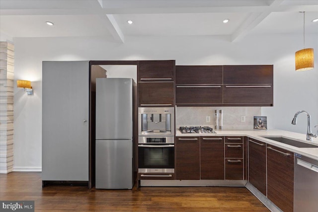 2223 1st St NW Unit 1, Washington, DC 20001 - kitchen with appliances with stainless steel finishes, beam ceiling, dark wood finished floors, dark brown cabinetry, and light countertops