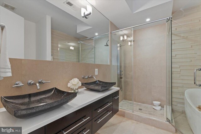 2223 1st St NW Unit 1, Washington, DC 20001 - full bath featuring tile patterned floors, double vanity, a stall shower, a freestanding bath, and recessed lighting