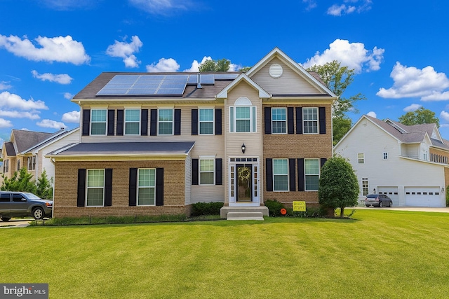 3275 Sutherland Ct, White Plains, MD 20695 - view of front of home featuring brick siding, roof mounted solar panels, a front lawn, and a garage