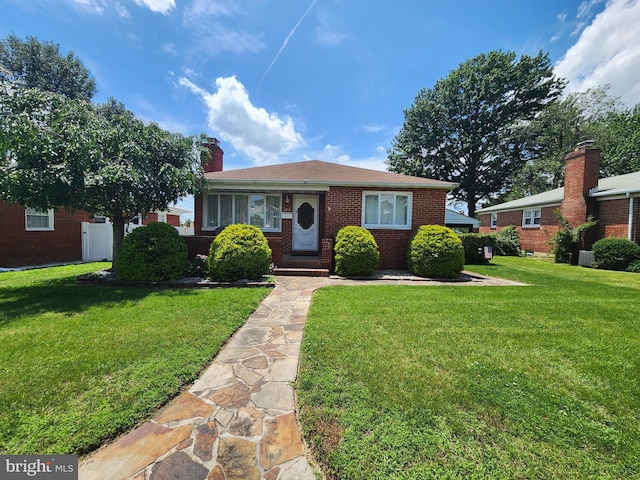 1814 Tyler Rd, Dundalk, MD 21222 - bungalow-style house with a front yard, brick siding, and a chimney